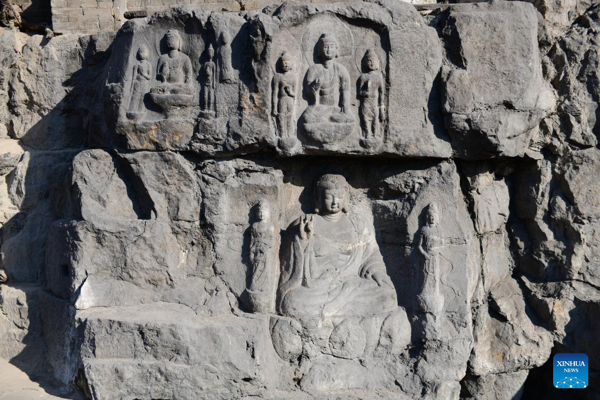 Buddha sculptures carved into cliff reemerge in north China